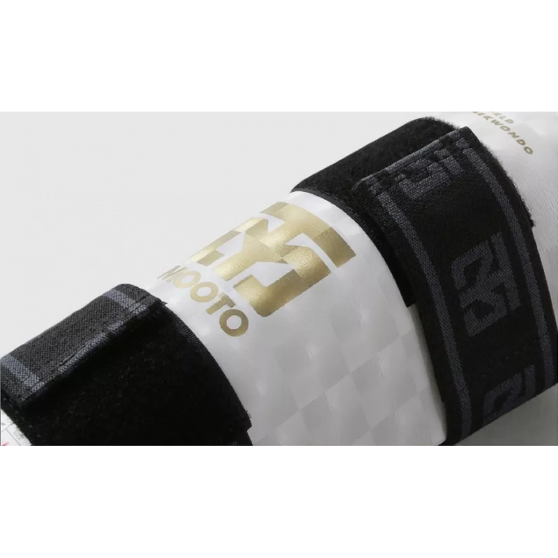 Protège bras zoomer sur le logo en or et l'attache